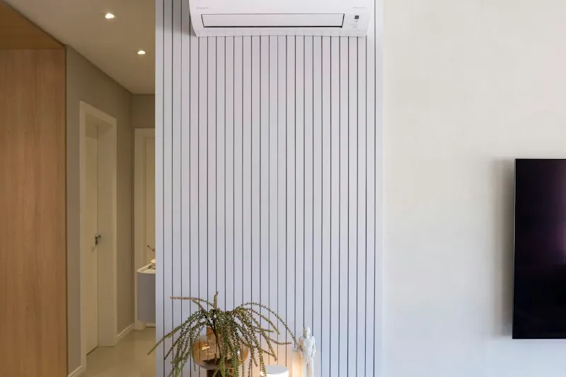 Clean modern condo living room with a wall-mounted split-type aircon